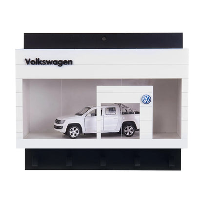 White Volkswagen wall key hook rack shaped like a miniature showroom with a silver scale model car inside.