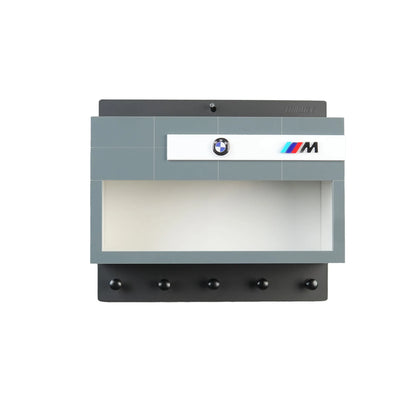 Gray BMW M-themed wall key hook rack with five black hooks and a display case slot.
