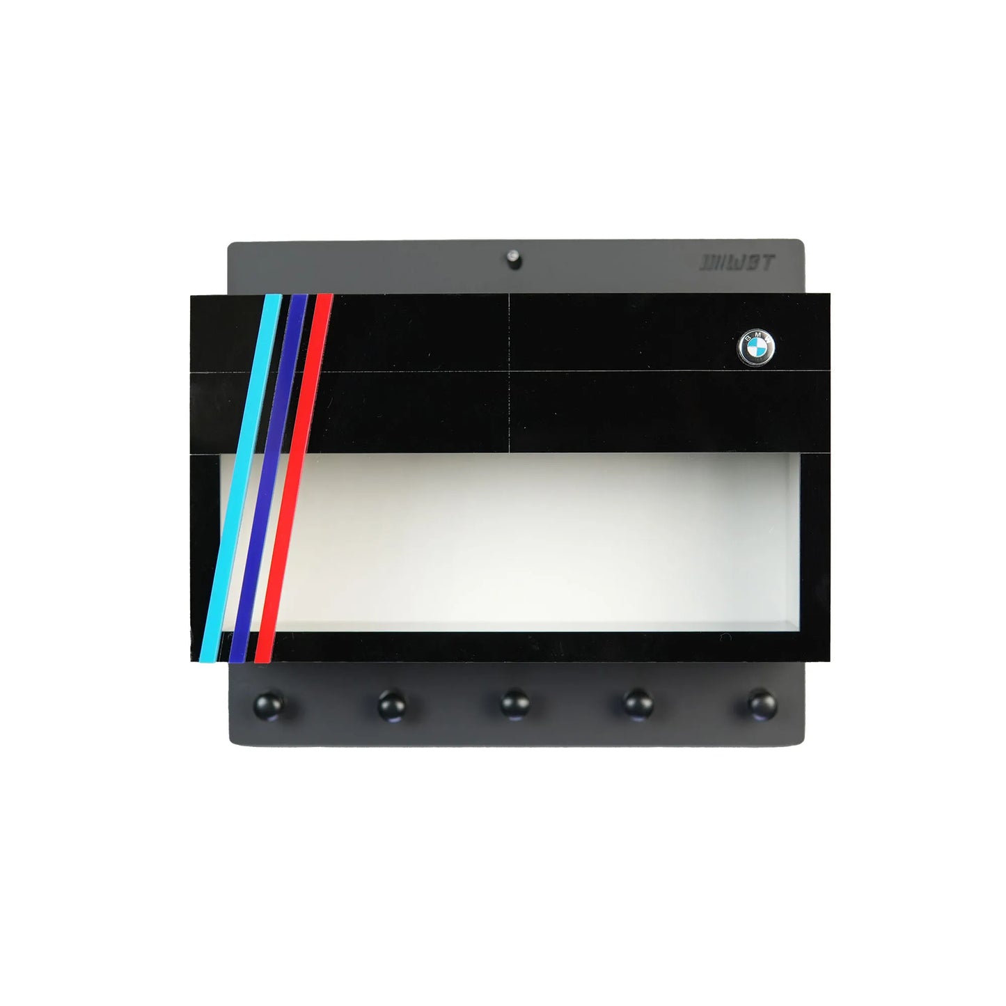 Black wall-mounted key hook rack with four silver hooks, decorated with BMW logo and red, blue, and light blue stripes,.
