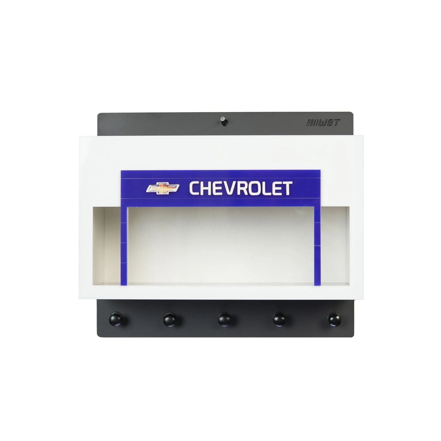 White and black wall-mounted key hook rack with Chevrolet logo and scale model car display case.