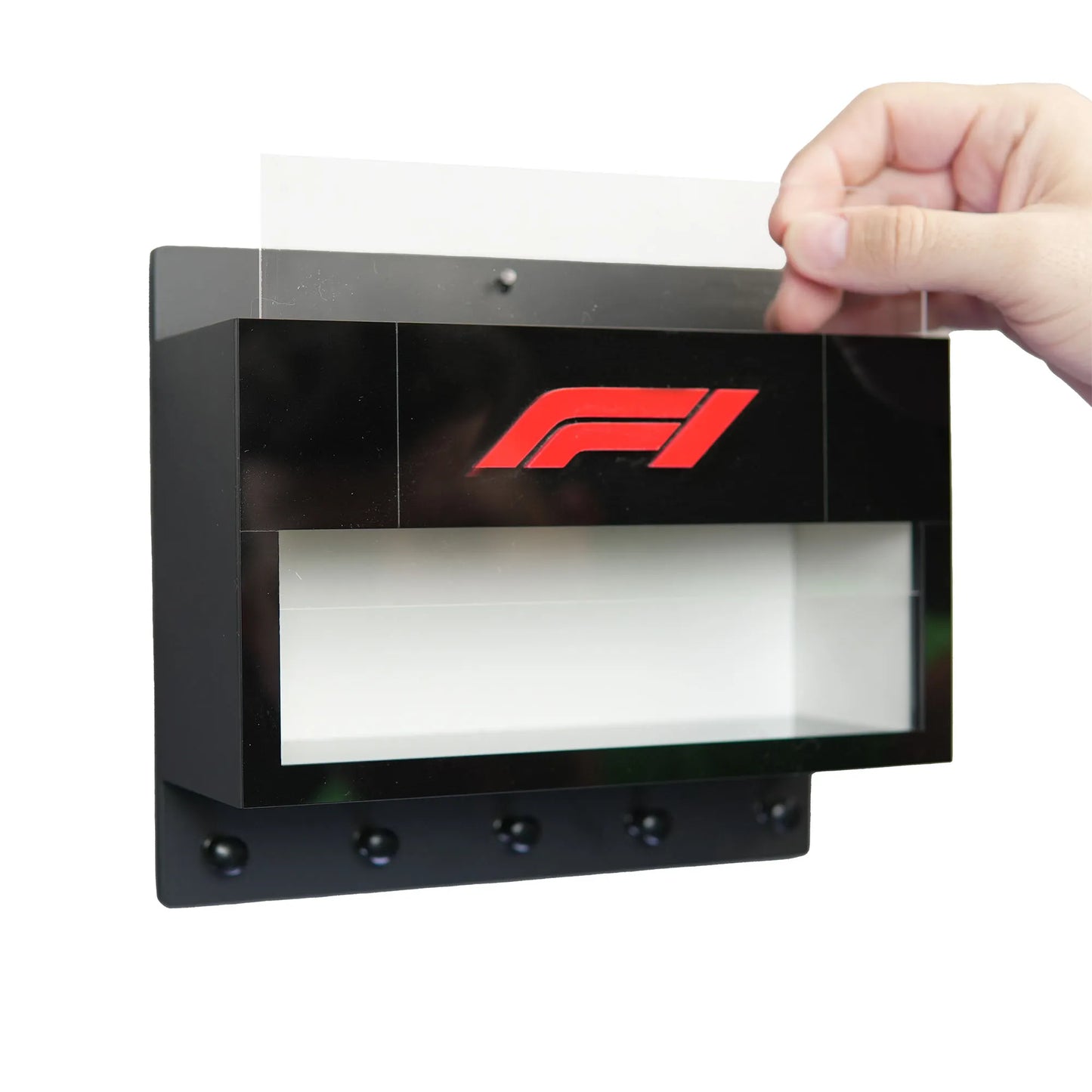 Black rectangular wall key hook rack with transparent display case and red F1 logo, five hooks below.