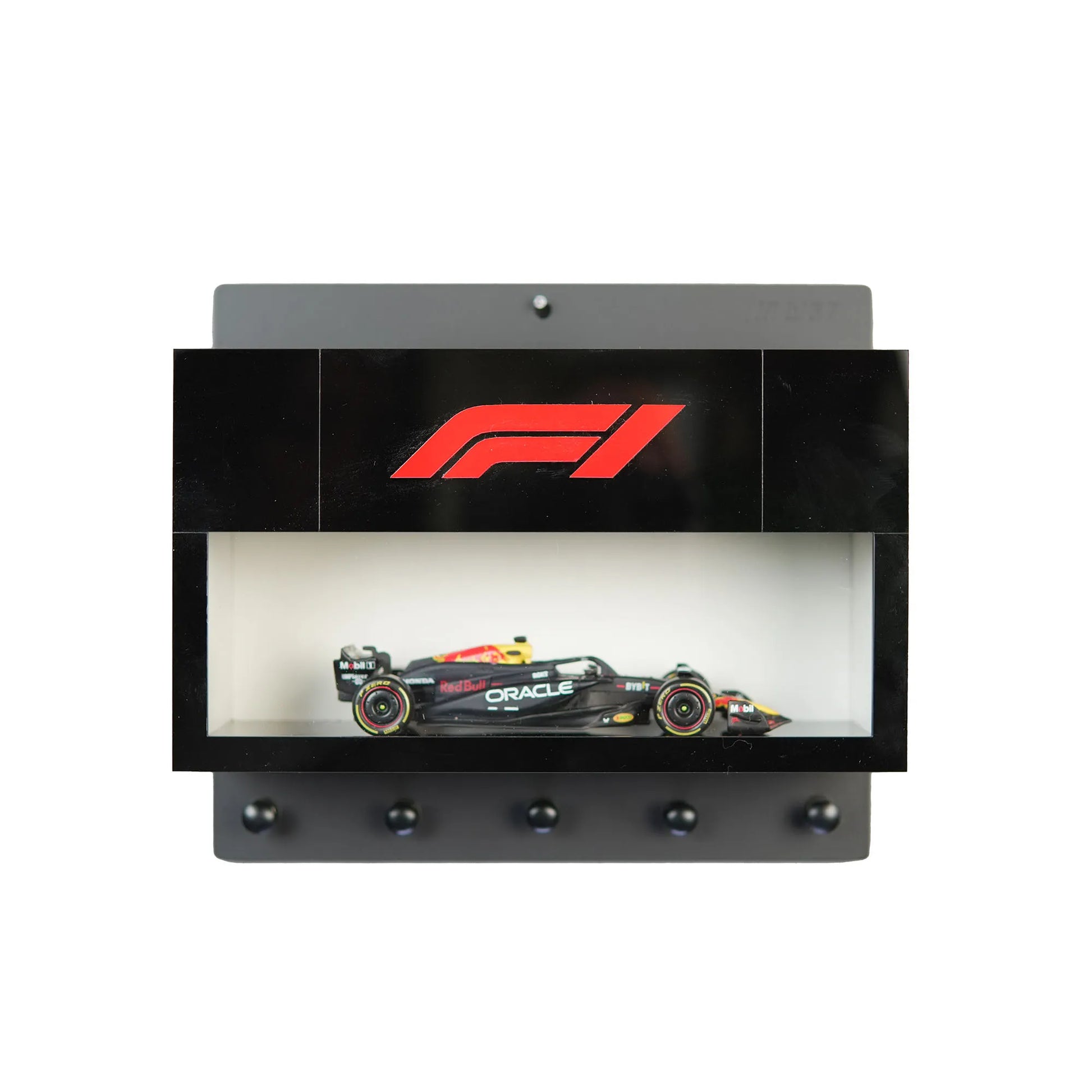 Black wall-mounted display case with F1 logo, holding a detailed black and red Formula One car model with five black key.