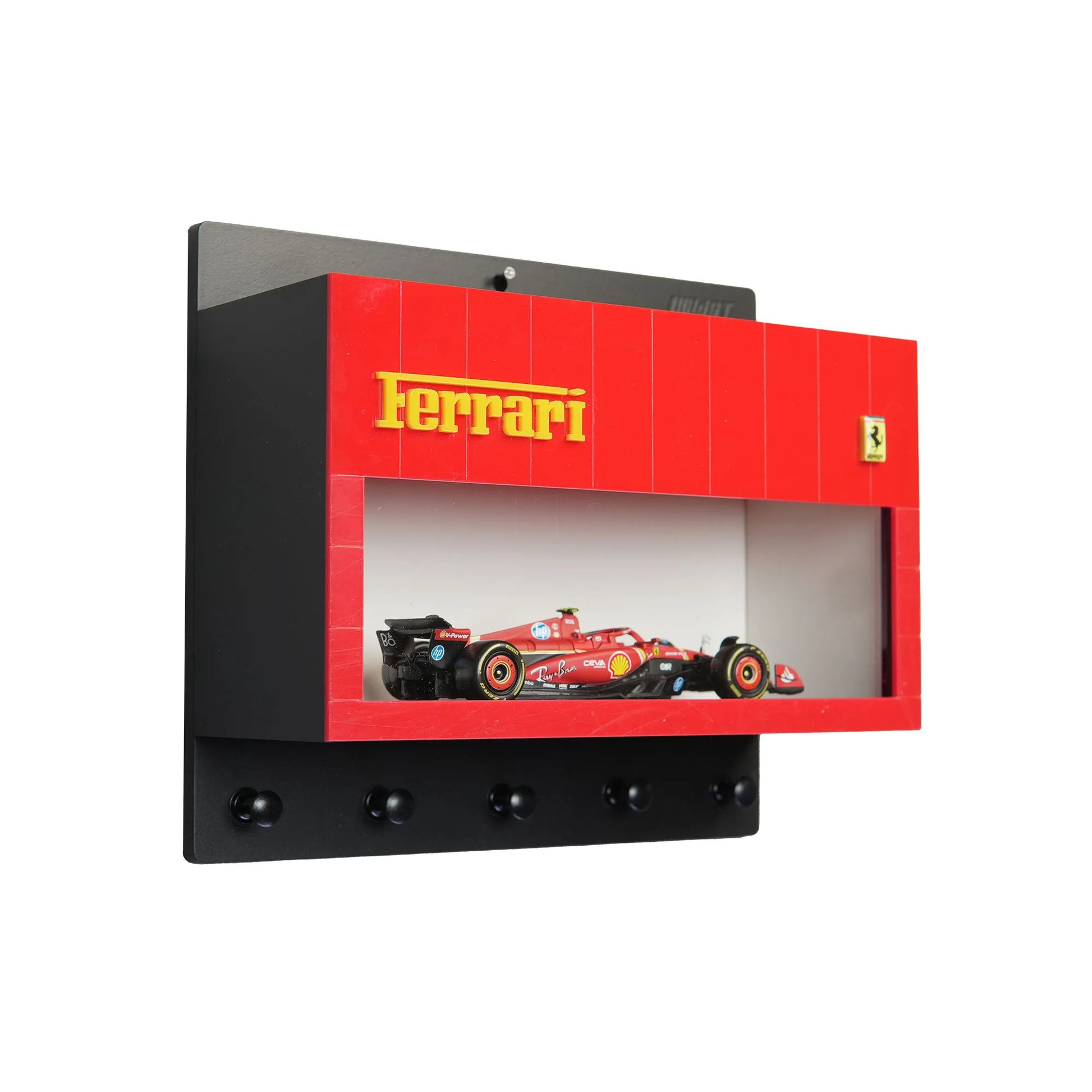 Black and red Ferrari wall-mounted key hook rack with scale model red Ferrari race car inside display case.