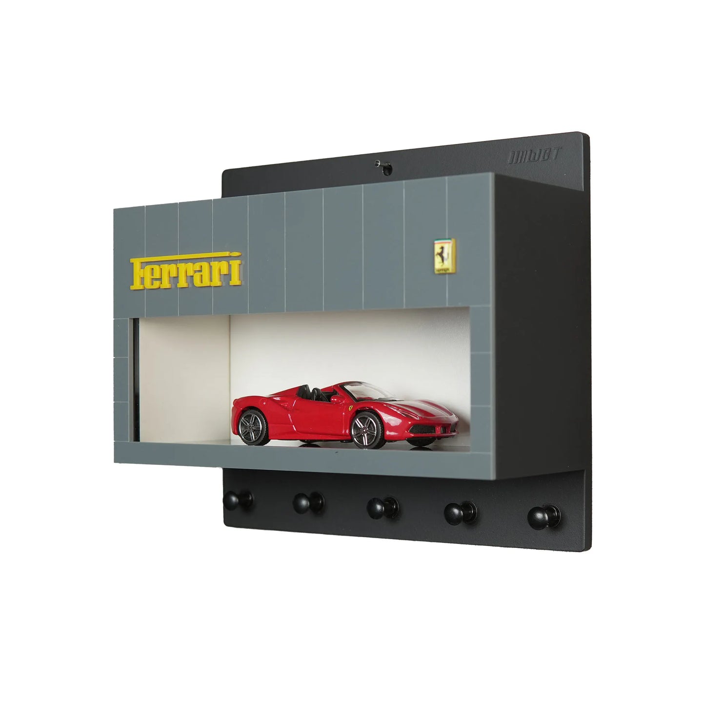 Gray Ferrari wall-mounted key hook rack with red scale model car and four black hooks.