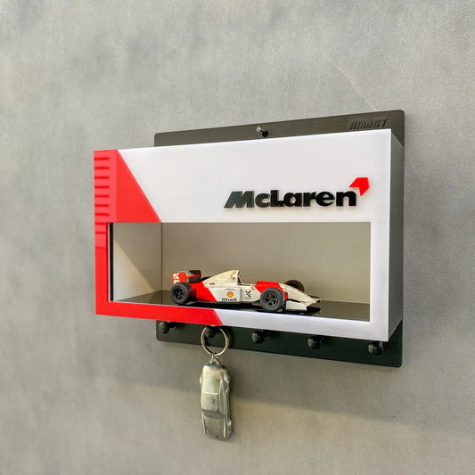 McLaren vintage F1 car display case wall key hook rack with white, red, and black design and a hanging car key.