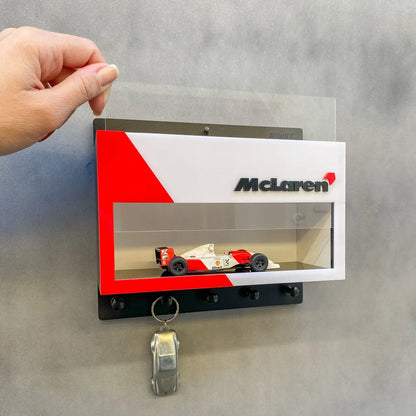 McLaren vintage F1 car model displayed in white and red wall-mounted key hook rack with three black hooks.