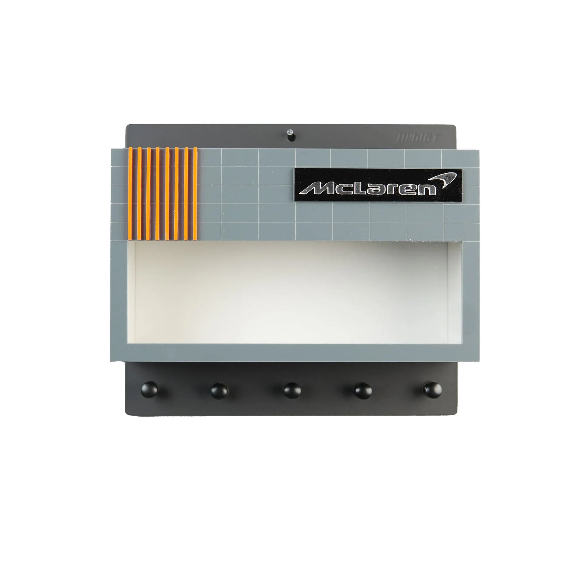Gray and black wall key hook rack with McLaren logo and orange stripes, six hooks below a display shelf.